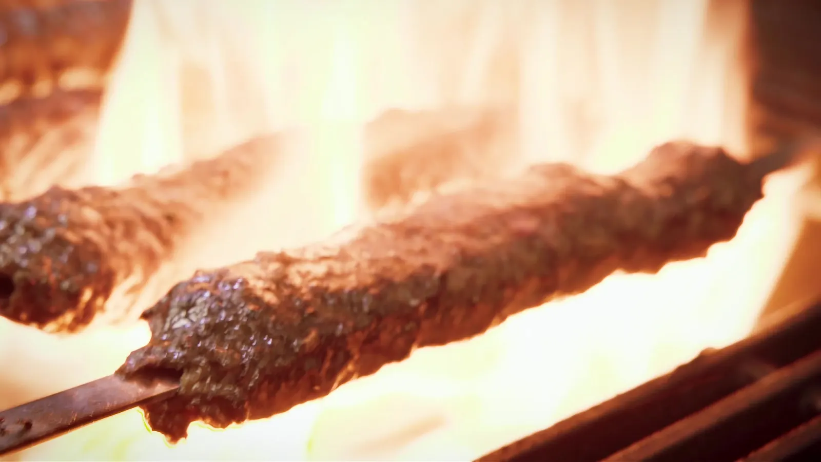 Hand-shaped Adana kebab on the grill