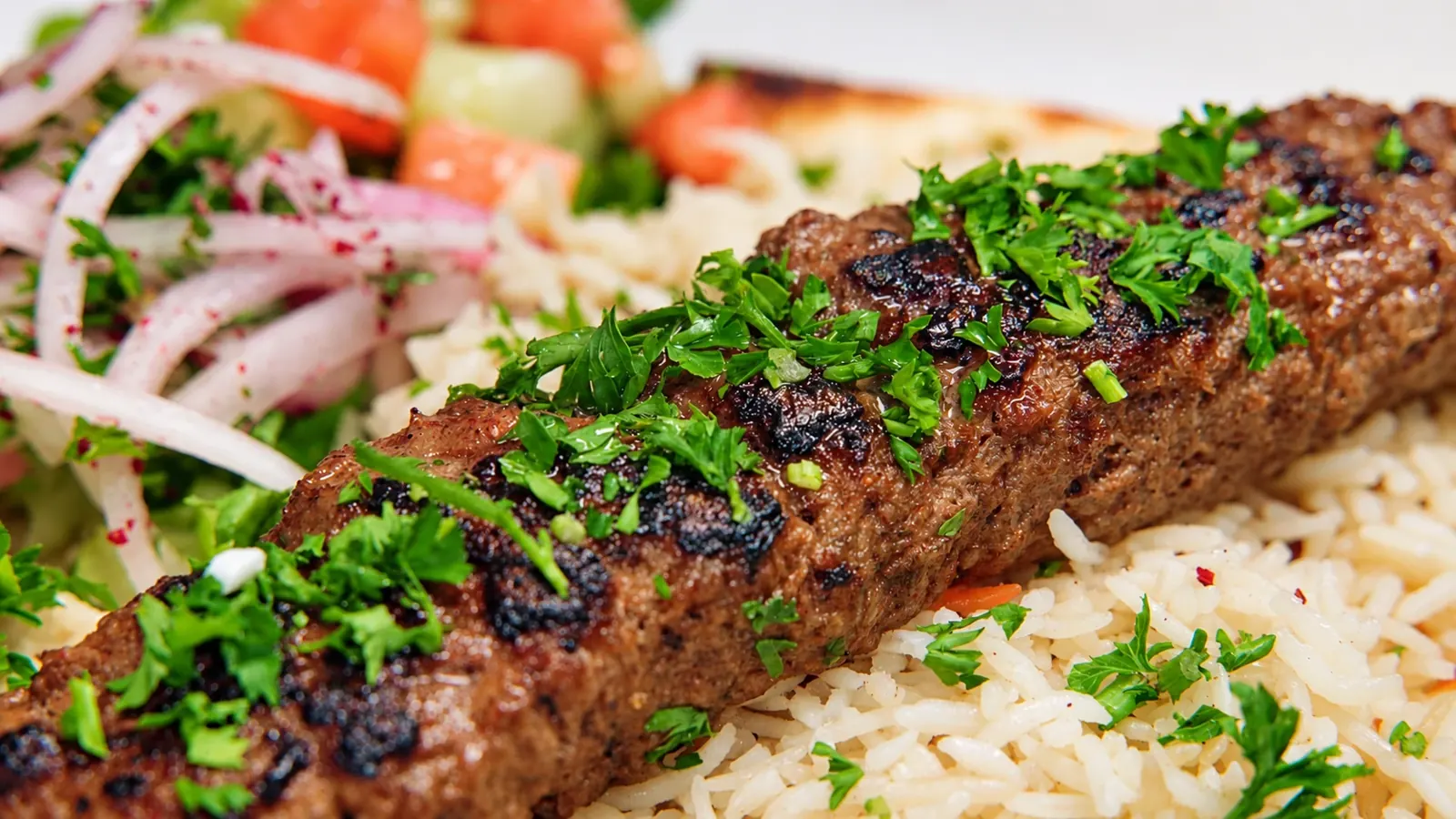 Adana kebab plate with rice and salad