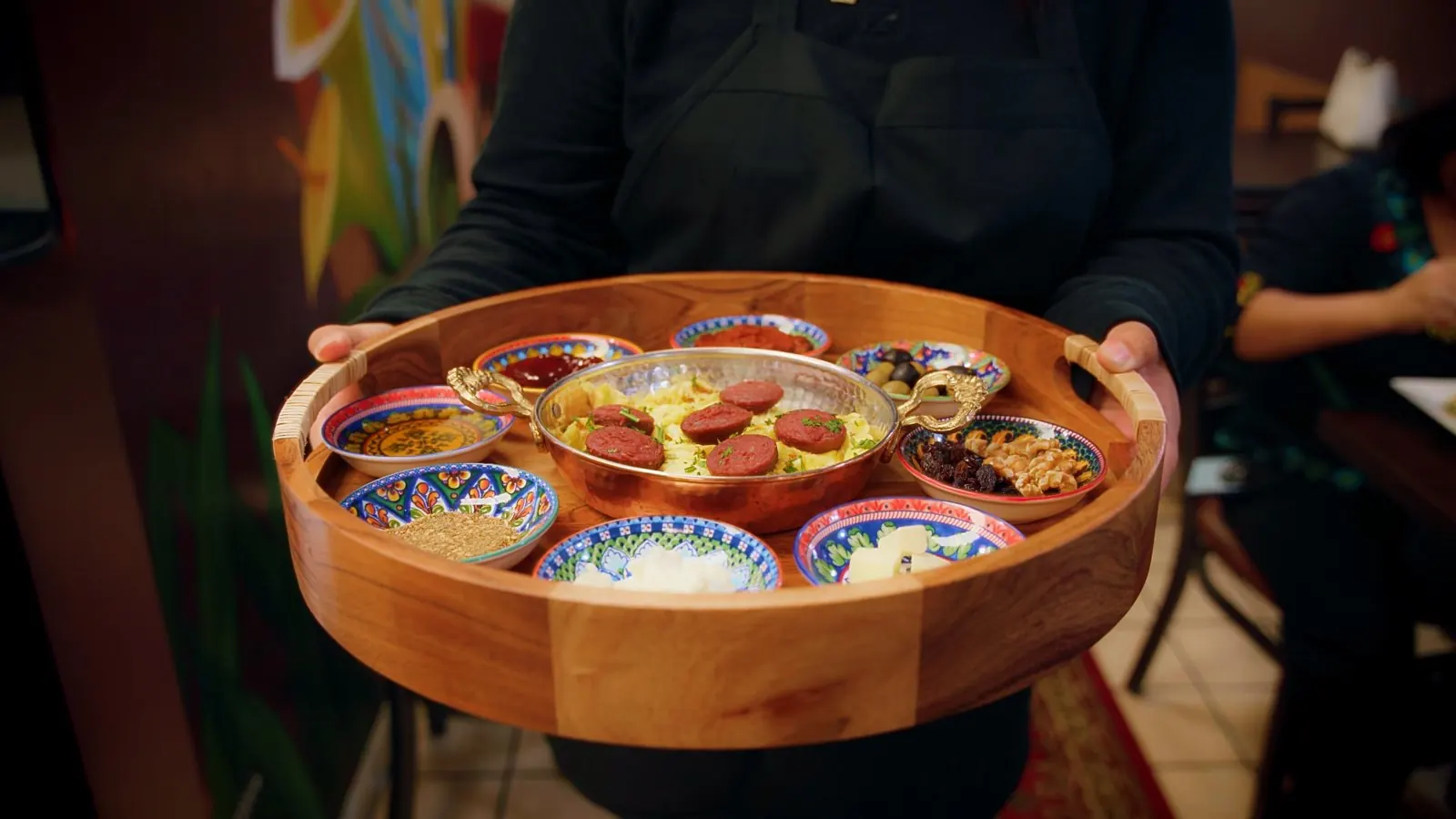 Turkish breakfast tray with menemen, olives and small plates