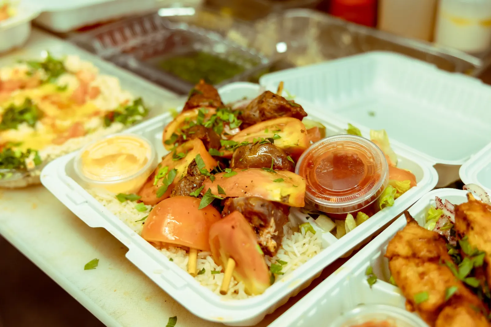 Lamb shish kebab plate with rice, tomato and sauces
