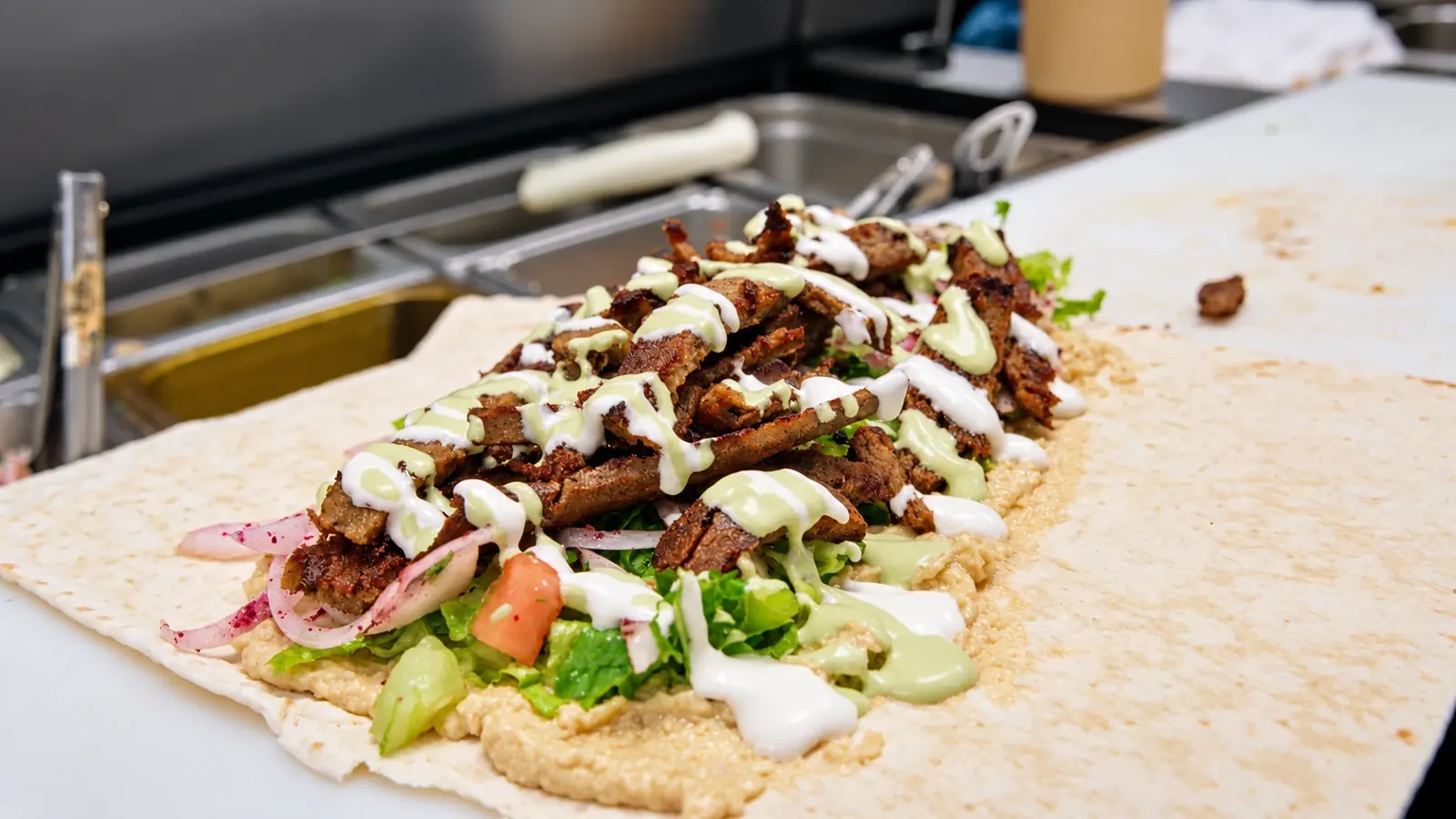 Aladdin wrap loaded with grilled meat, vegetables and sauces